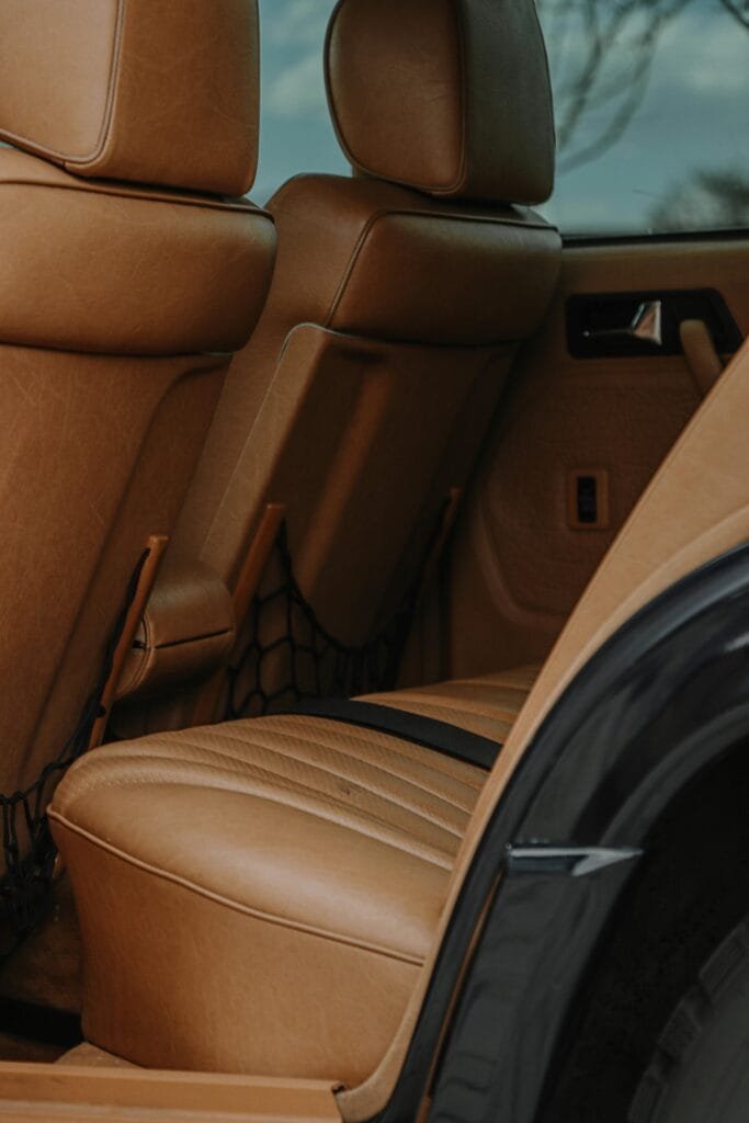 Close-up of a luxurious tan leather car interior showcasing elegant seating and design.